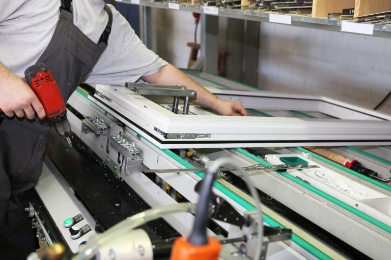 A man diligently working on a machine, showcasing his skills in a well-equipped industrial setting.